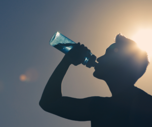 A man drinking water when out in the sun